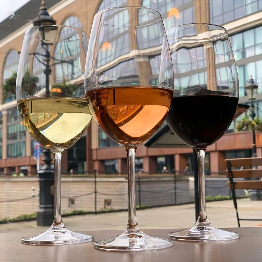 White, rosé and red wine on the terrace, with Ivory House behind